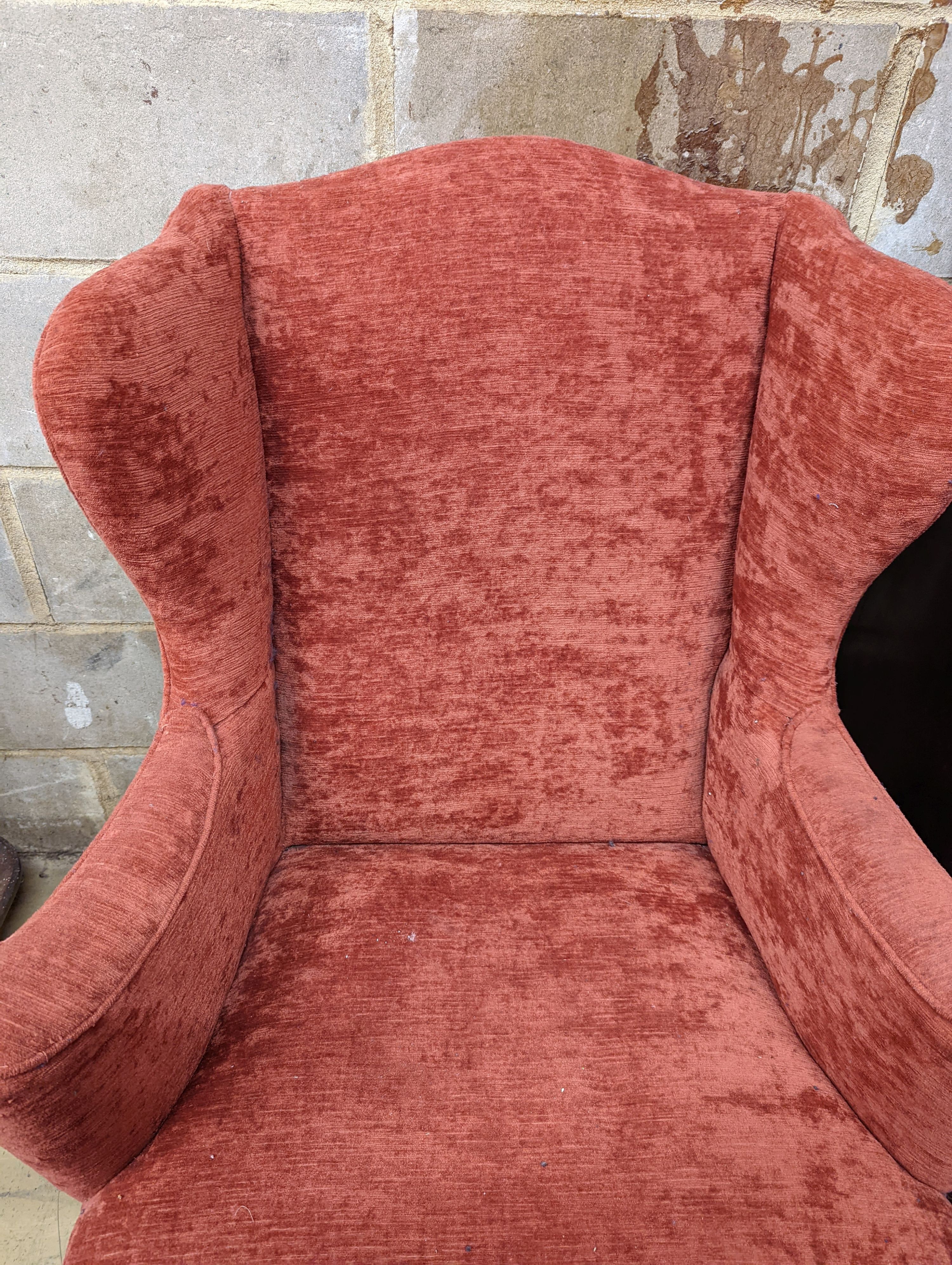 A Queen Anne style upholstered wingback armchair, width 78cm, depth 77cm, height 102cm